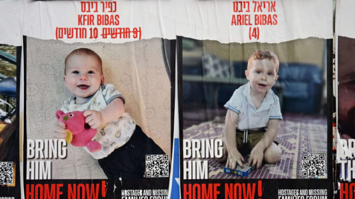 People Pass Posters of Israeli Hostages Held By Hamas In Gaza, Jerusalem, Israel - 31 Dec 2023
