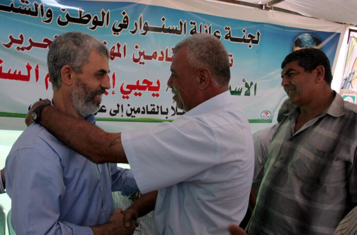 Freed Palestinian Hamas leader Yehia Sinwar, greets supporters following his release from an Israeli jail .